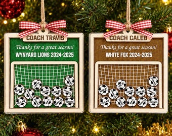 May include: Two square wooden ornaments with red and white gingham bows. One is green, one is brown. Both feature a soccer goal graphic, the text "Thanks for a great season!", team names, and small circular soccer ball tokens with names.