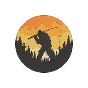 May include: Embroidered patch featuring a silhouette of Bigfoot fishing. The design includes a forest scene with a sunset in shades of orange and yellow. The patch is circular and has a black border.