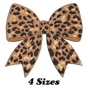 Pode incluir: Um laço marrom e preto com estampa de leopardo e um detalhe dourado. 4 tamanhos.