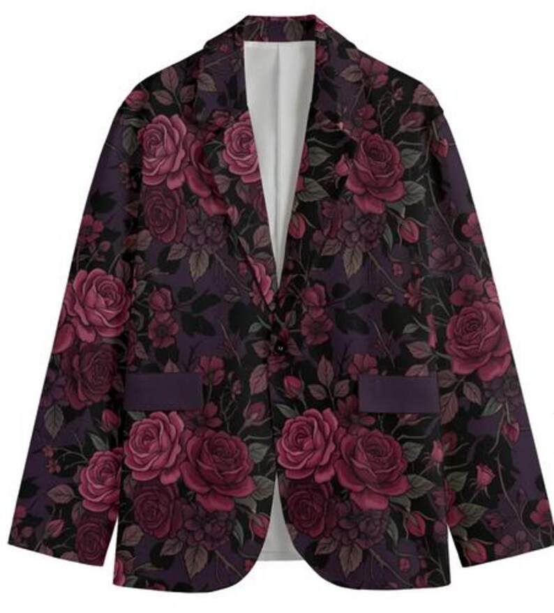 May include: A floral blazer featuring a dark purple background with a pattern of burgundy roses and green leaves. The blazer has a single-button closure, two pockets, and a white interior lining. This jacket is a stylish addition to any wardrobe.