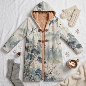 May include: A long-sleeved hooded coat featuring a light-colored landscape print with cranes, trees, and lanterns. The coat has a tan faux-fur lining and two brown toggle closures on the front. It is displayed alongside beige cable-knit mittens.