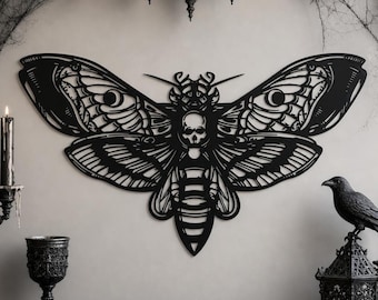 May include: A black metal wall art piece shaped like a death's-head hawkmoth with intricate cut-out wing patterns and a skull design on the thorax. The moth is displayed centrally, featuring symmetrical wings and a detailed segmented body structure.