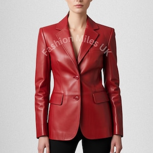 May include: A red leather blazer with a classic tailored design. The blazer features a notched lapel, two front pockets, and a single-button closure. The sleeves are long, and the jacket is worn over black pants. The text "Fashion Miles UK" is visible on the blazer.