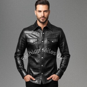 May include: Black button-down shirt with a crocodile skin texture. The shirt has two chest pockets and a classic collar. The long-sleeved shirt is made of a shiny, textured material.