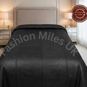 May include: A black leather bedspread featuring a grid-like stitched pattern. A circular logo in the top right corner displays the text Fashion Miles UK Genuine Leather. The bedspread covers the entire surface of the bed in a bedroom setting.