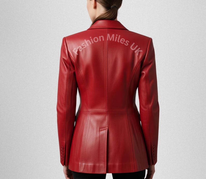 May include: A vibrant red leather blazer with a classic tailored design. The jacket features a notched lapel, buttoned cuffs, and a single-button closure. The text "Fashion Miles UK" is printed on the back of the blazer.