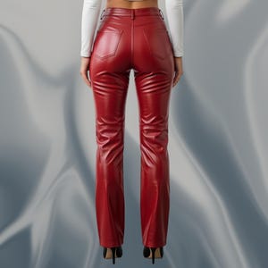 May include: A pair of red leather pants with a high waist and a flared leg. The pants have two back pockets and a zipper closure. The model is wearing black high heels. The pants are made of a shiny, smooth material.