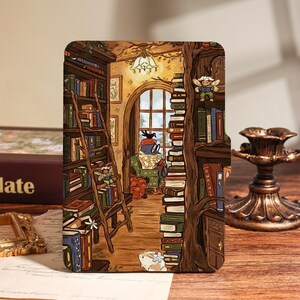 May include: A rectangular e-reader cover featuring a detailed illustration of a cozy library interior with tall bookshelves, a wooden ladder, a large arched window, a bird reading in an armchair, and small fairy figures among stacks of books.