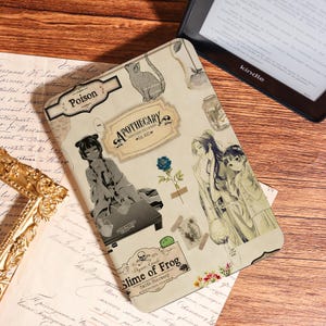 May include: Kindle case with an apothecary theme. The case is beige with illustrations of anime characters, a cat, and labels that read "Poison", "Apothecary", and "Slime of Frog". A Kindle e-reader is partially visible in the background.