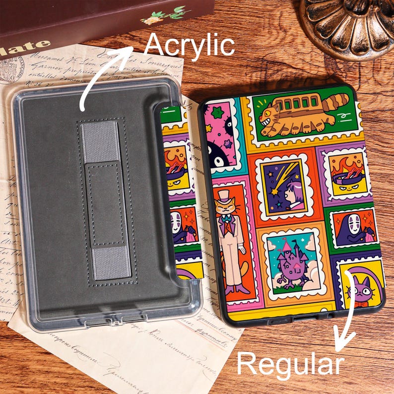 May include: An acrylic phone case with a colorful design featuring various cartoon characters in a stamp-like pattern. The case is shown next to a clear acrylic case with a gray interior and a stand.