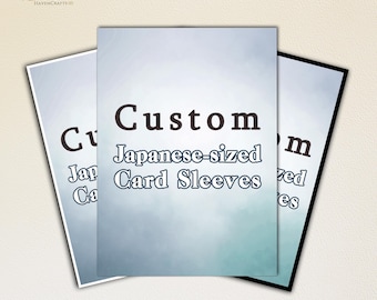 May include: Three custom Japanese-sized card sleeves are displayed, each with a gradient blue and white background. The text "Custom Japanese-sized Card Sleeves" is printed on the front of the sleeves.