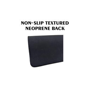May include: Close-up of a black, textured neoprene surface. The image displays a portion of a product with the text "NON-SLIP TEXTURED NEOPRENE BACK" in bold, black letters. The surface has a diagonal ribbed pattern.