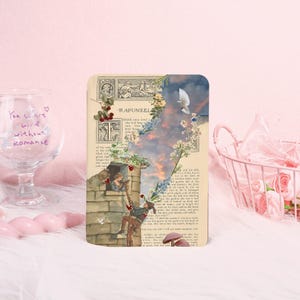 May include: A decorative book page with the word "Rapunzel" and a collage of a tower, a man climbing, and a woman. The page is decorated with floral and heart accents, evoking a fairytale theme.