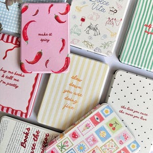 May include: A white ceramic mug with a black handle and the text "But First, Coffee" in a bold, black font. The mug is sitting on a wooden surface. The mug is 4 inches tall.