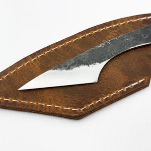 Blade on leather sheath, close-up - kiridashi marking knife with 52100 steel edge.