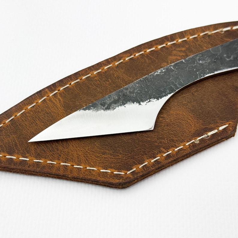 Blade on leather sheath, close-up - kiridashi marking knife with 52100 steel edge.