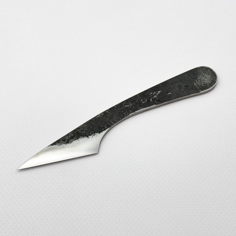 Hand-forged kiridashi on white background, steel Japanese marking knife.
