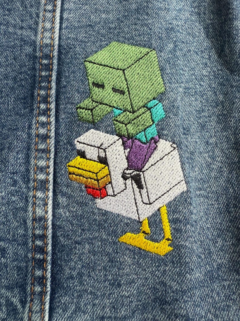 May include: A green Minecraft zombie riding a white chicken on a blue denim background.