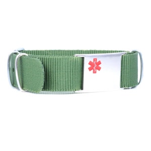 May include: A green nylon dog collar with a silver medical alert tag featuring a red star of life symbol.