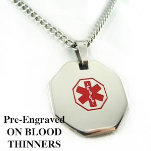 May include: Silver medical alert necklace with a red star of life symbol and the words "ON BLOOD THINNERS" engraved on the pendant.