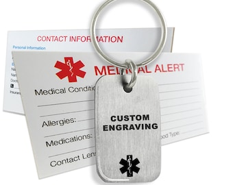 May include: A silver medical alert keychain with a red star of life and the text "CUSTOM ENGRAVING". The keychain is attached to a silver key ring.