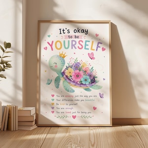 May include: A framed art print featuring a cartoon turtle with a crown and a shell adorned with colorful flowers. The print has the text "It's okay to be YOURSELF" and positive affirmations. Butterflies and hearts decorate the background.
