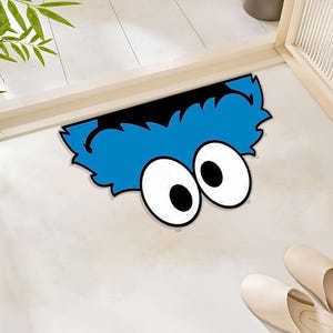 Divertida alfombra peluda azul con asomarse: un divertido y caprichoso detalle de piso inspirado en dibujos animados para un espacio acogedor y animado. Alfombra de poliéster.