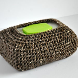 May include: A brown crocheted tissue box cover with a bright green plastic lid.