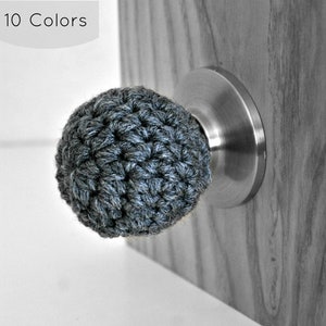 May include: A gray crocheted door knob cover, 10 Colors, on a silver door knob.
