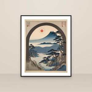 May include: A framed art print featuring a landscape illustration viewed through a dark arched frame. The scene depicts a mountain peak, a red sun, blue rolling hills, and pine trees on rocky terrain. Japanese characters are visible in the corners.