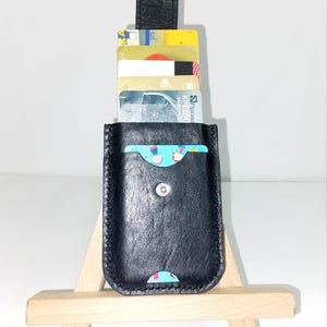 May include: A set of three ceramic mugs with a speckled, matte finish. Each mug is a different colour: light blue, cream, and grey. The mugs have a simple, modern design, ideal for coffee or tea.