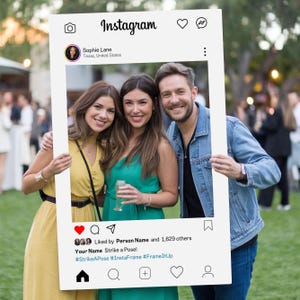 May include: A white photo booth prop shaped like an Instagram post with a white frame and a black and white photo of three people smiling. The text on the prop reads "Instagram", "Sophie Lane", "Texas, United States", "Liked by Person Name and 1,629 others", "Your Name Strike a Pose!", "#StrikeAPose #InstaFrame #FrameItUp".