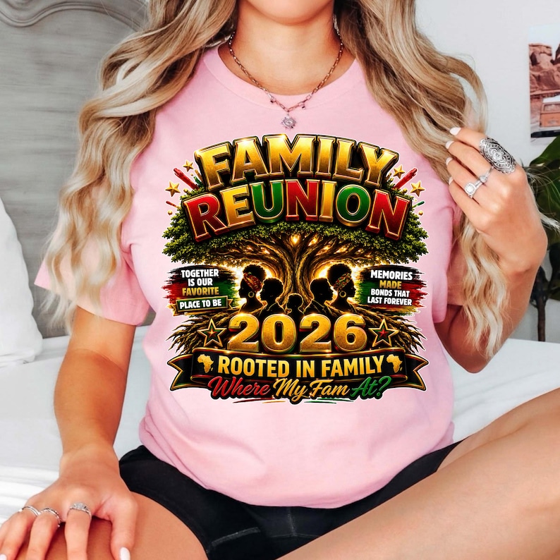 May include: A light pink t-shirt featuring a graphic print with the text FAMILY REUNION, 2026, ROOTED IN FAMILY, and Where My Fam At? The design includes a large tree, silhouettes of people, and red, yellow, and green accents throughout.