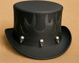 May include: Black leather top hat with flame-shaped cutouts around the crown. The hat features a brim and a band adorned with three silver skull accents. A stylish accessory.
