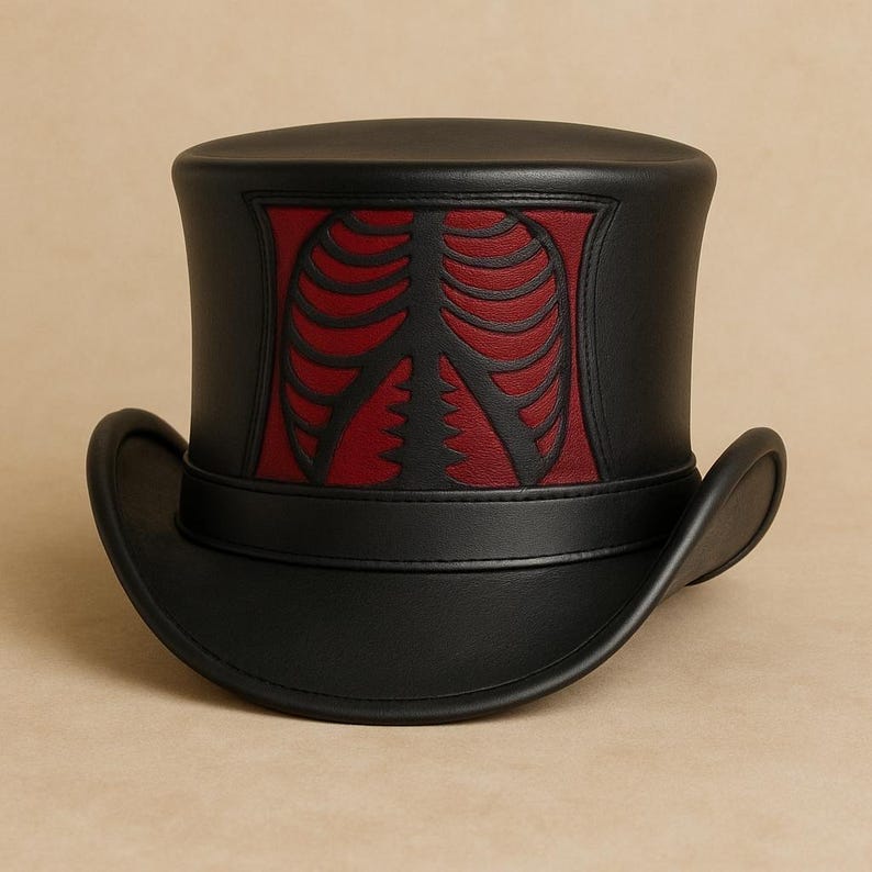 Pode incluir: Cartola preta com um design de caixa tor&aacute;cica vermelho e preto. O chap&eacute;u tem uma aba curva e uma coroa cil&iacute;ndrica. O design da caixa tor&aacute;cica &eacute; centrado na frente do chap&eacute;u. O chap&eacute;u &eacute; feito de couro.
