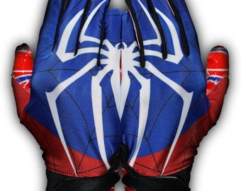 May include: Pair of blue, red, and white gloves featuring a spider web design with a large white spider emblem. The gloves have black wrist straps and red accents on the fingertips.