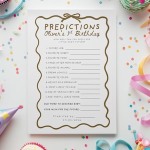 May include: A white ceramic mug with a black handle and the text "But First, Coffee" in a black, handwritten-style font. The mug is on a white surface.