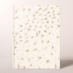 May include: A hardcover journal with a cream-colored cover featuring a pattern of flying birds in shades of brown and beige. The birds are depicted in various positions, creating a sense of movement and flight.