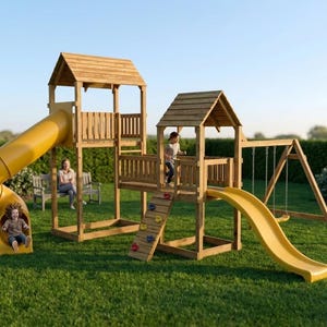 May include: A wooden outdoor playset featuring two elevated platforms with gabled roofs, a yellow spiral tube slide, a yellow straight slide, a climbing wall with colorful handholds, and a swing set with two hanging swings on a grassy lawn.