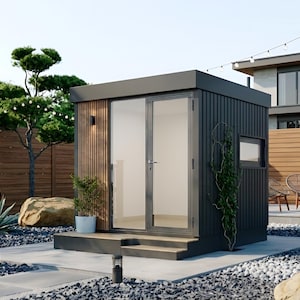 May include: A modern, dark gray outdoor shed with a flat roof and glass double doors. The shed has a wooden accent wall and is surrounded by a landscaped yard with trees, rocks, and a wooden fence. The scene is well-lit with natural light.