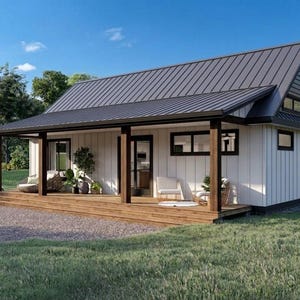 Op de afbeelding: Een gelijkvloers huis met witte verticale gevelbekleding, een donker metalen dak en een brede houten veranda. De buitenkant is voorzien van donker omlijste ramen en deuren, met buitenmeubilair op het terras onder de overkapping.