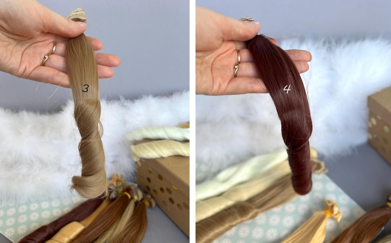 May include: Two bundles of hair extensions, one light brown with the number 3, and the other dark red with the number 4. The extensions are held up against a white fluffy background, with other bundles of hair in various shades.