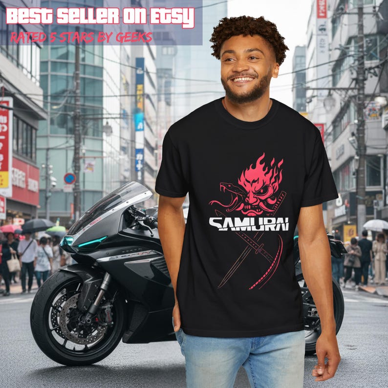 May include: Black t-shirt with a red and white graphic of a samurai mask and the word "SAMURAI". The image also includes a black motorcycle and the text "BEST SELLER ON ETSY" and "RATED 5 STARS BY GEEKS".