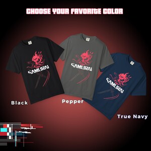 May include: Three t-shirts in black, pepper, and true navy. Each shirt features a red graphic of a samurai mask with the word "SAMURAI" and crossed swords. The text "CHOOSE YOUR FAVORITE COLOR" is at the top.