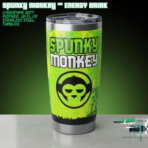 May include: A stainless steel tumbler with a green and yellow design, featuring the text "SPUNKY MONKEY" and a monkey face logo. The tumbler is 20 fl oz and has a black lid. The text "CYBERPUNK 2077 INSPIRED" is also visible.