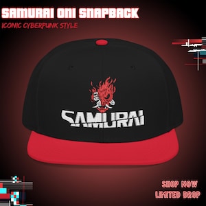 May include: A black snapback hat with a red brim and a red button on top. The front features an embroidered red oni mask graphic above the white text SAMURAI. The text SAMURAI ONI SNAPBACK and ICONIC CYBERPUNK STYLE appear at the top of the image.