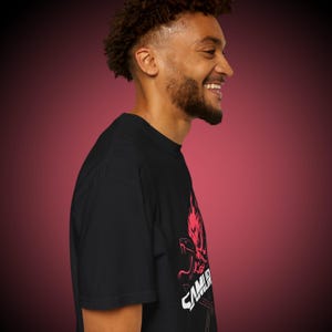 May include: Black t-shirt with a red and white graphic design. The design features a stylized dragon and the word "SAMURAI". The shirt is made of a soft material and has a classic crew neck.