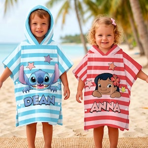 May include: Two children wearing hooded beach towels. One towel is light blue with horizontal stripes, a Stitch graphic, and the name "DEAN". The other is red and white striped with a Lilo graphic and the name "ANNA".