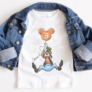 May include: A set of three ceramic mugs with a speckled, matte finish. The mugs are in shades of cream, light gray, and dark gray. Each mug has a simple, minimalist design and a rounded handle.