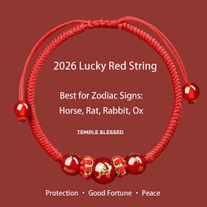 May include: A red string bracelet with adjustable sliding knots and red beads. The bracelet features the text "2026 Lucky Red String" and "Best for Zodiac Signs: Horse, Rat, Rabbit, Ox". Additional text includes "TEMPLE BLESSED", "Protection • Good Fortune • Peace".